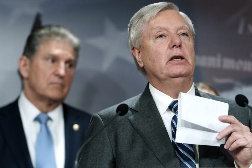 Sen. Lindsey Graham, R-S.C., right, with Sen. Joe Manchin, D-W.Va., speaks about their bill to ban Russian energy imports, Thursday, March 3, 2022, on Capitol Hill in Washington. (AP Photo/Jacquelyn Martin)