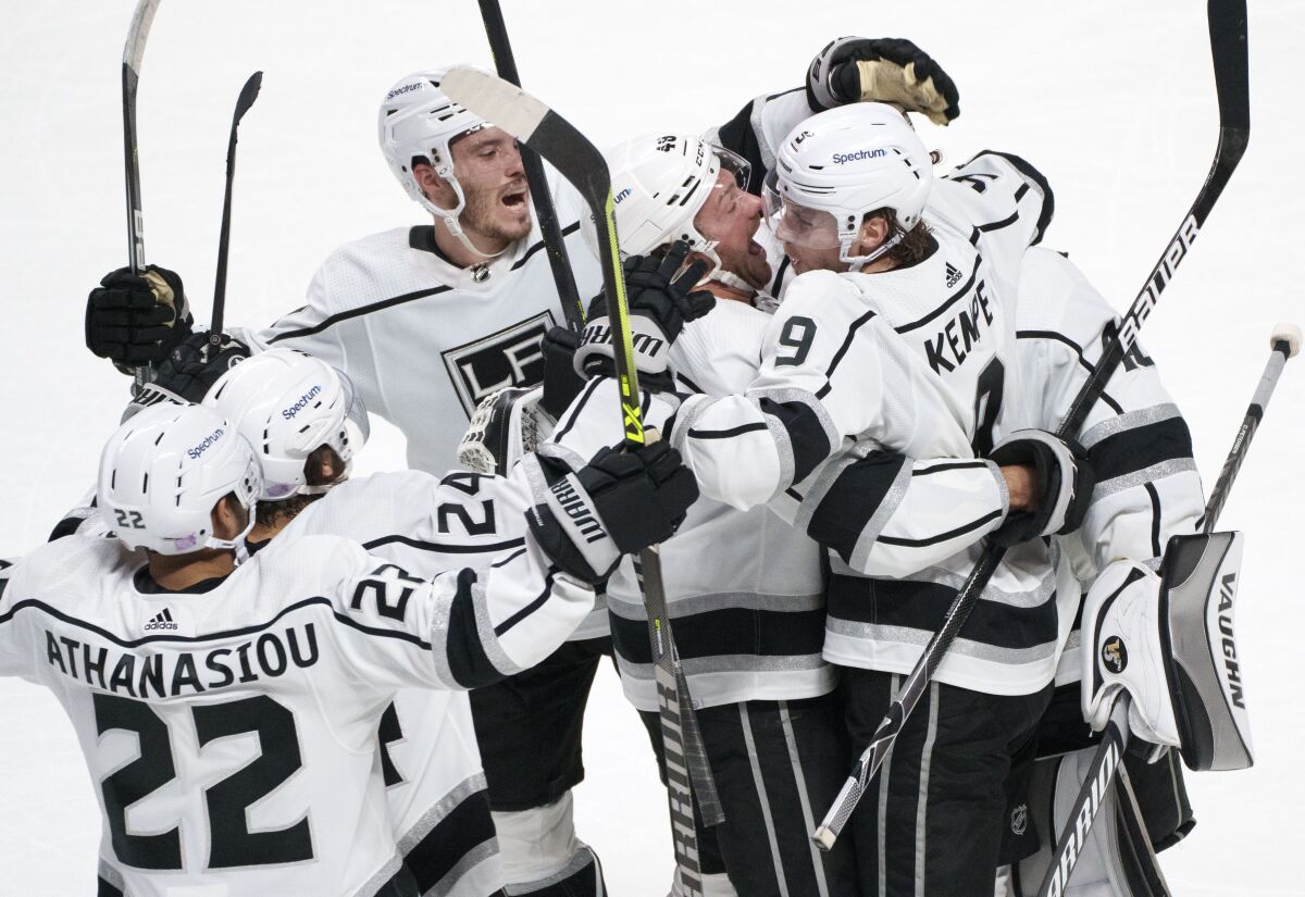 Los Angeles Kings' Adrian Kempe (9) celebrates with teammates after scoring the game-winning goal against the Montreal Canadiens during overtime in NHL hockey game Tuesday, Nov. 9, 2021, in Montreal. (Paul Chiasson/The Canadian Press via AP)