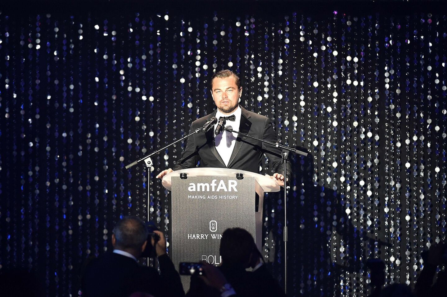 Actor Leonardo DiCaprio conducts an auction during the amfAR's 23rd Cinema Against AIDS Gala.