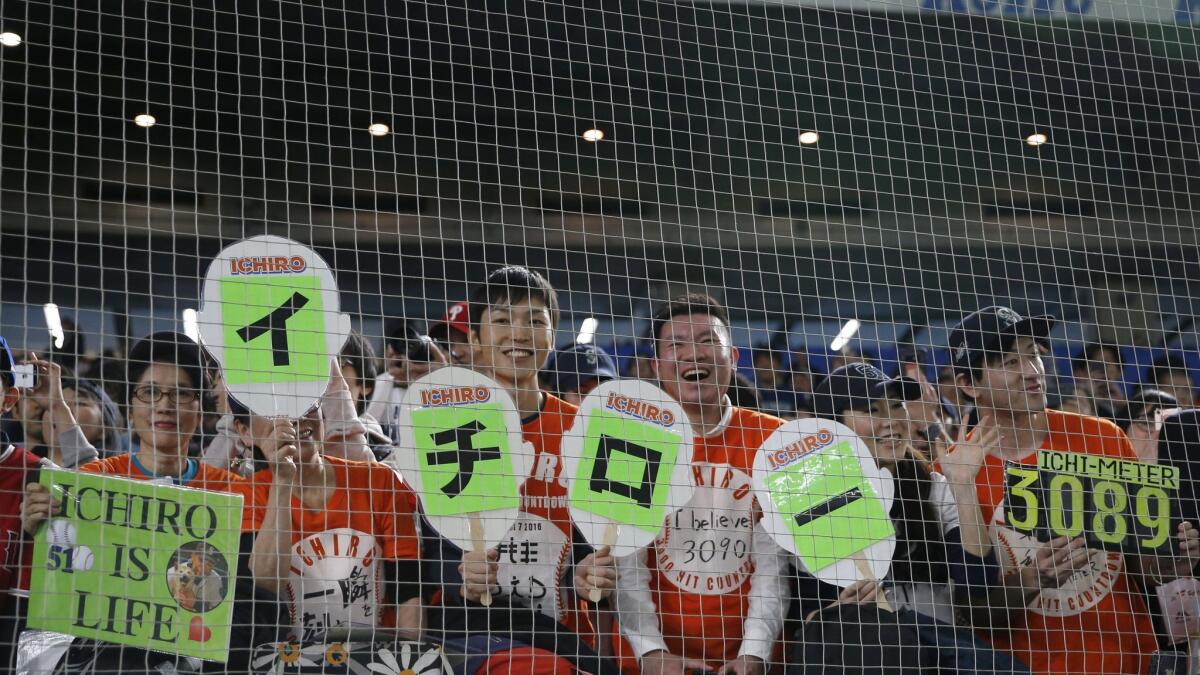 Fans at the Tokyo Dome cheer for Seattle Mariners outfielder Ichiro Suzuki before Tuesday's game against Oakland.