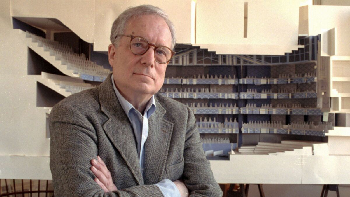 Robert Venturi in his office in Philadelphia in 1991, with a model of a new hall for the Philadelphia Orchestra in background.