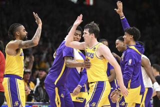 Lakers guard Austin Reaves, center, celebrates with the bench during the first half.