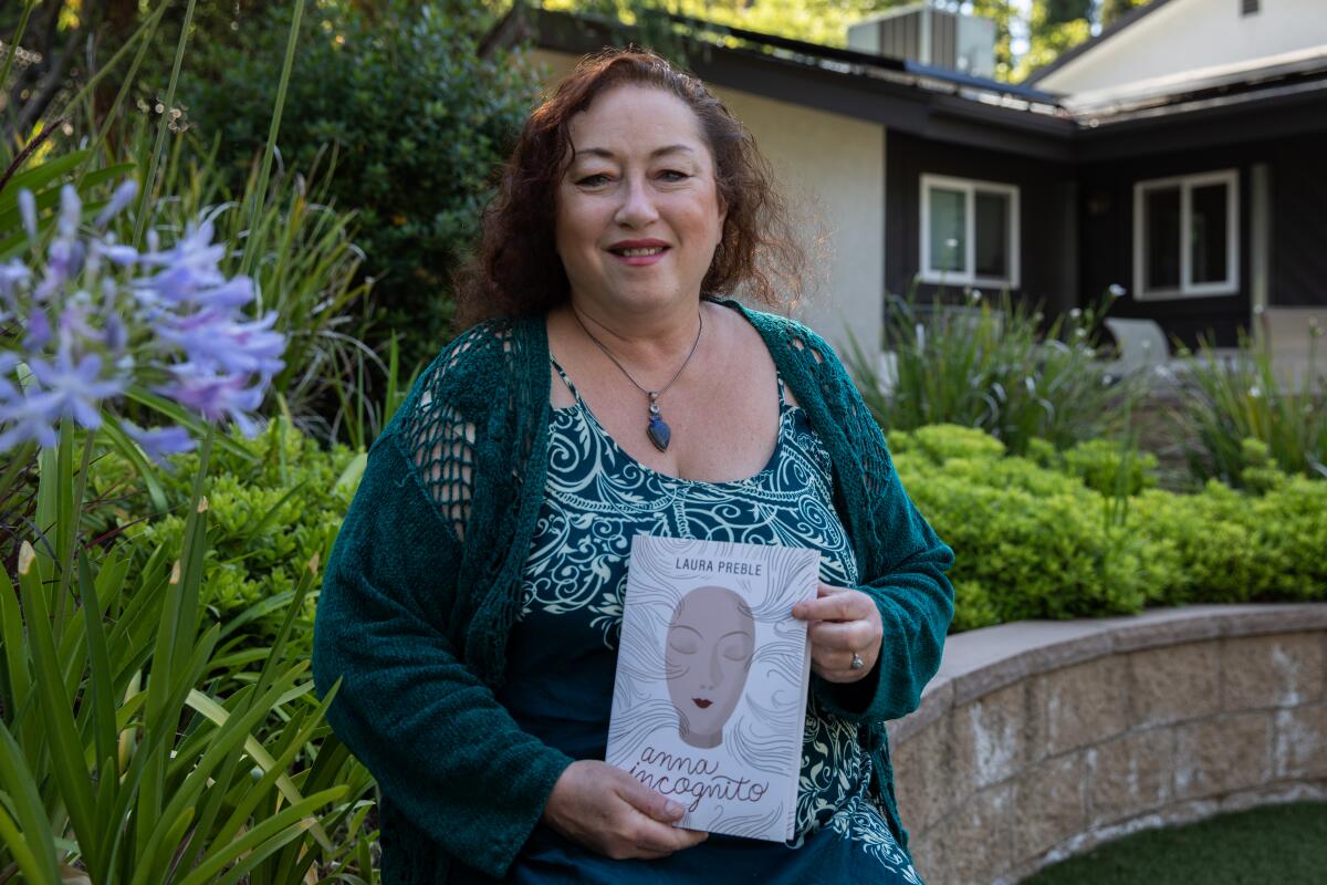  San Diego author Laura Preble poses for a portrait at her home in Rancho San Diego.