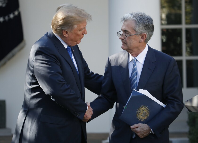 President Trump, shown shaking hands with Federal Reserve board member Jerome H. Powell in 2017 after nominating him for Fed chairman, suggested Friday that Powell was a bigger enemy of the U.S. than Chinese President Xi Jinping.