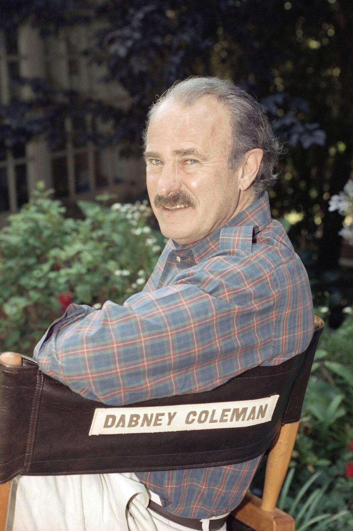 Dabney Coleman sits in a directors chair with his name on it