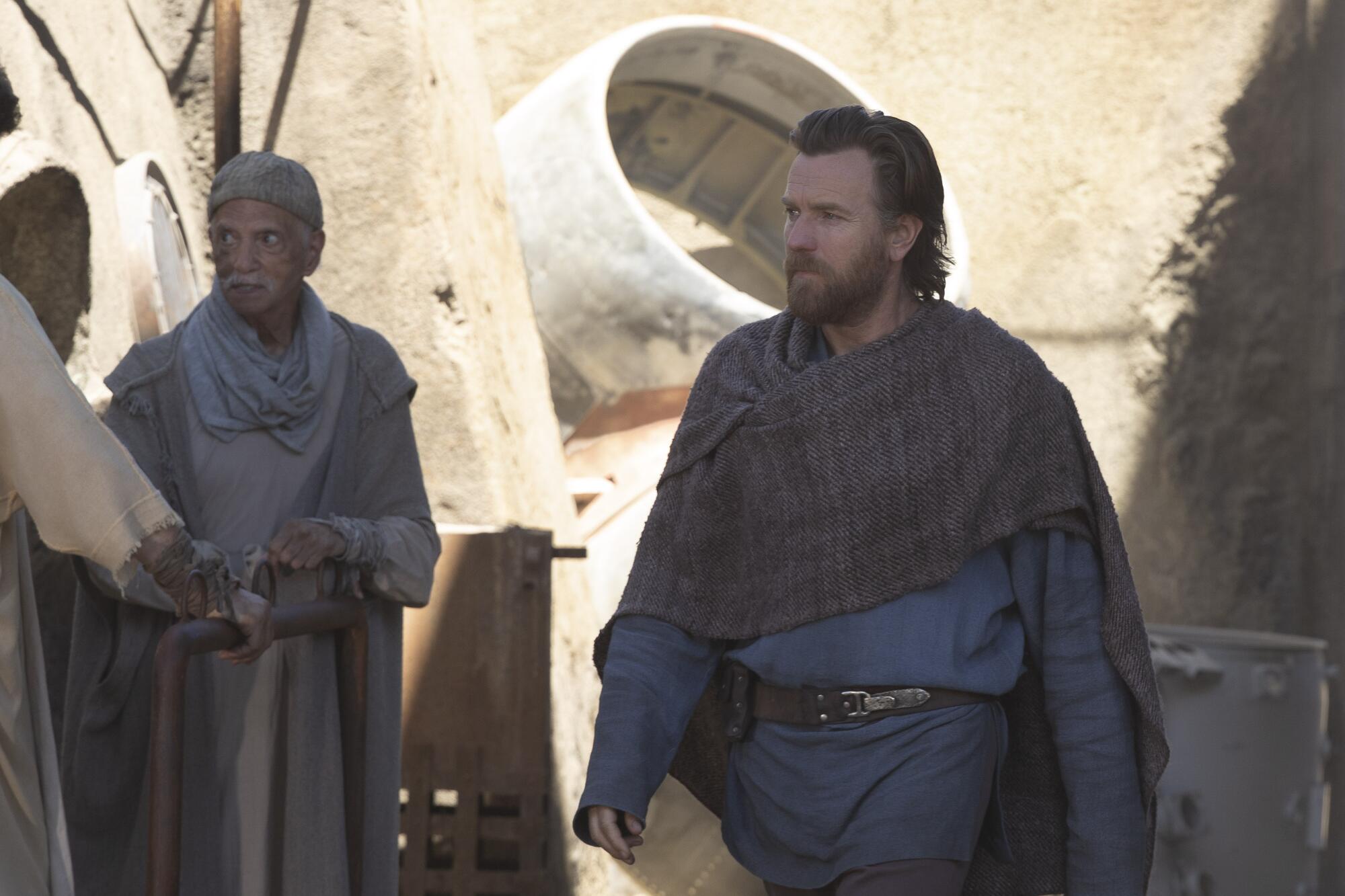A bearded man walking through a town from the series. "Obi-Wan Kenobi."