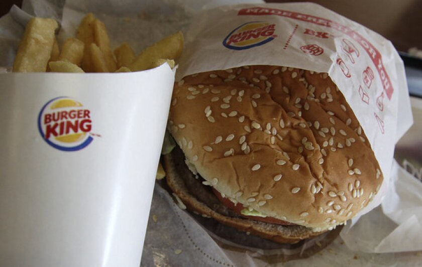 Burger King's third-quarter profit topped analyst estimates despite tanking 83%.