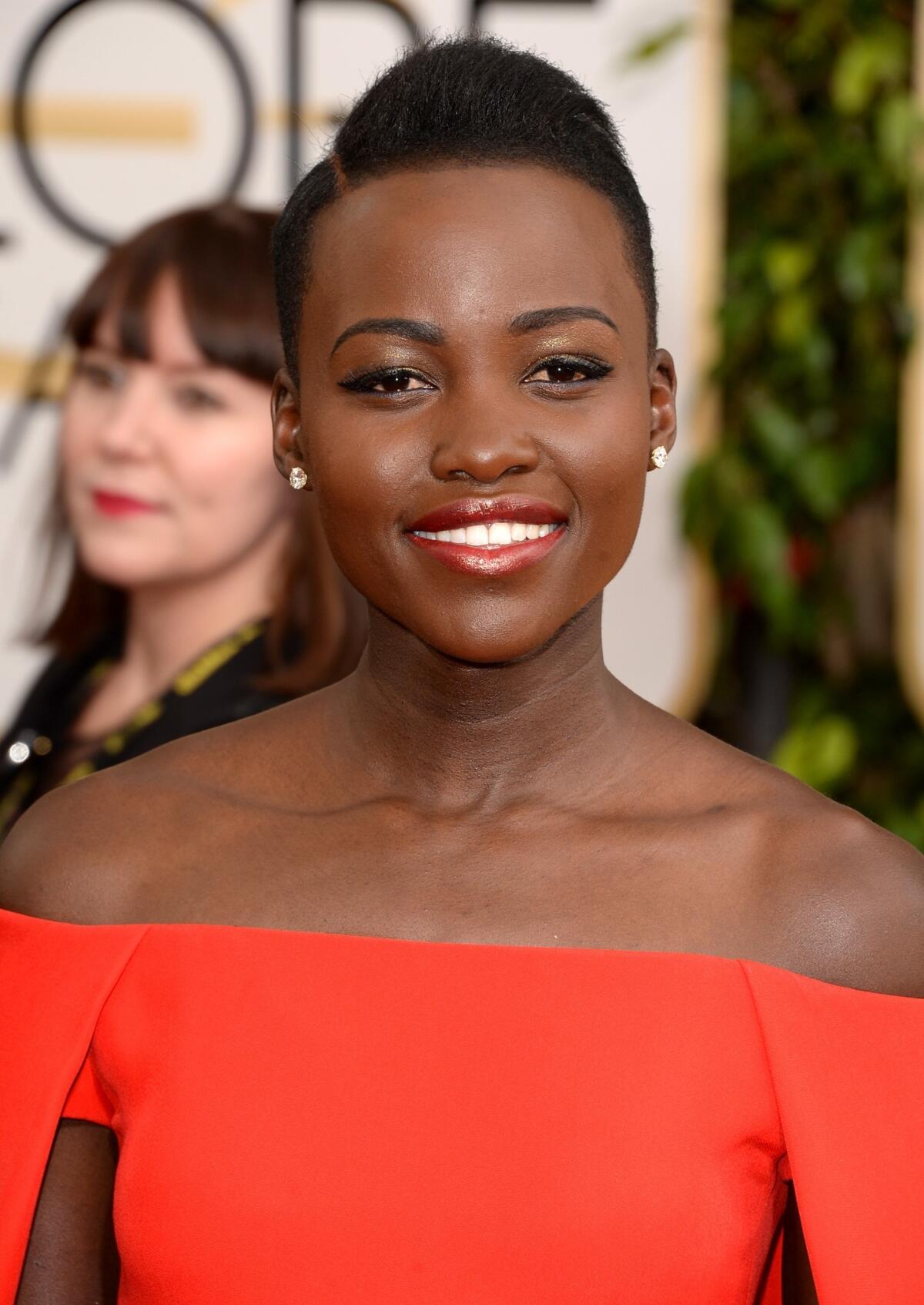 Actress Lupita Nyong'o's sleek hairdo was a perfect match to her dramatic red Ralph Lauren dress.