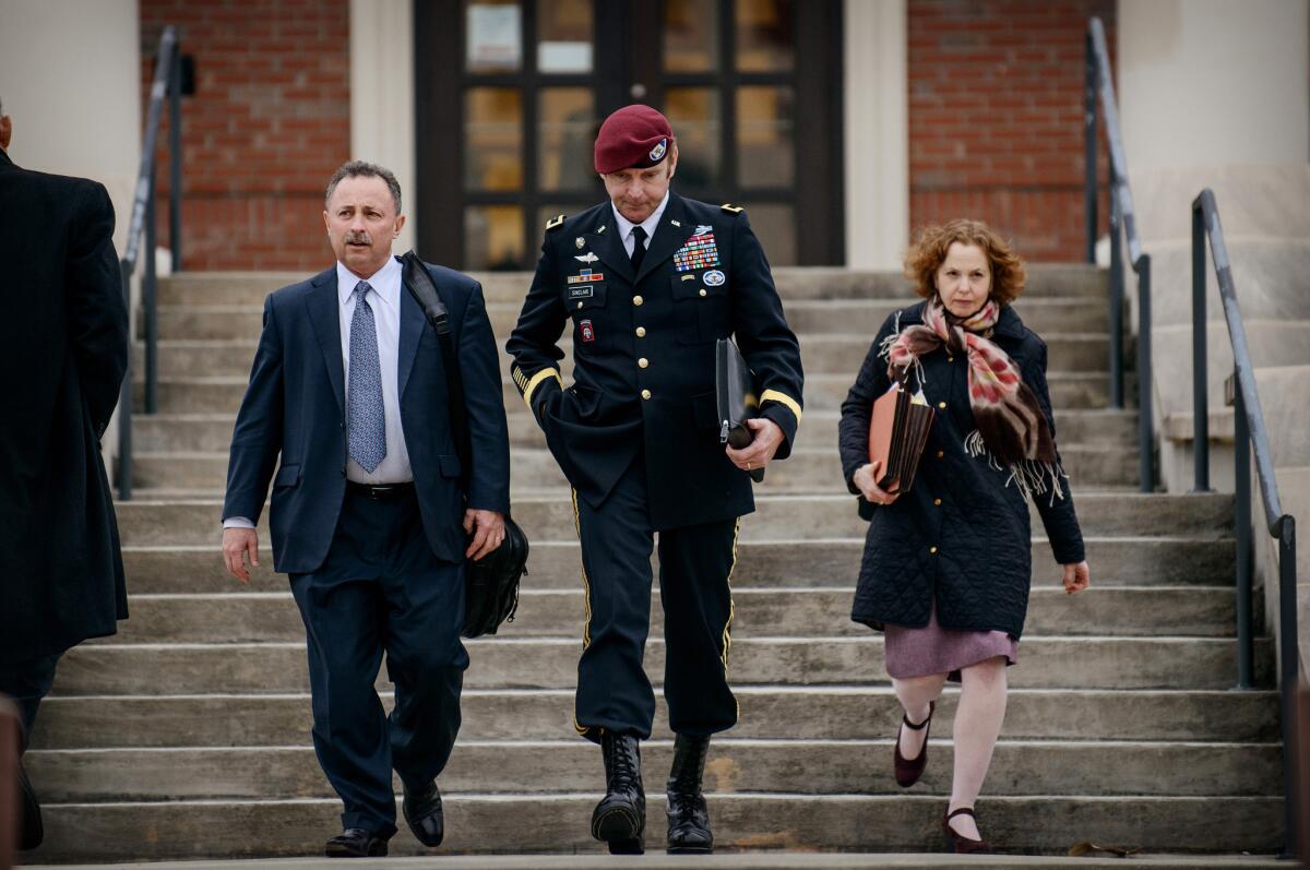 Brig. Gen. Jeffrey Sinclair leaves the courthouse on March 4 with his lawyers Richard Scheff, left, and Ellen C. Brotman.