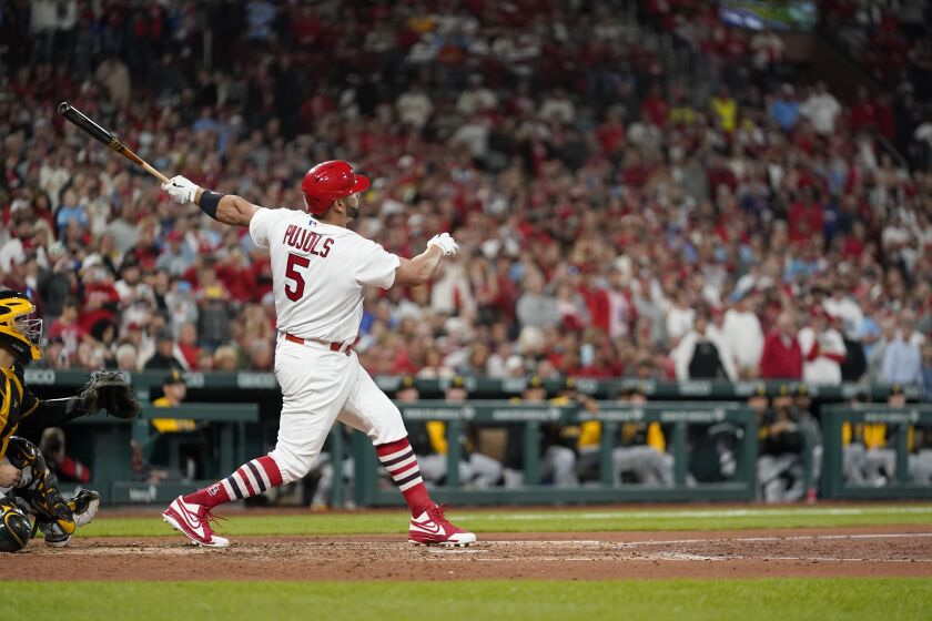 St. Louis Cardinals' Albert Pujols follows through on a solo home run during the fourth inning of a baseball game against the Pittsburgh Pirates Friday, Sept. 30, 2022, in St. Louis. (AP Photo/Jeff Roberson)