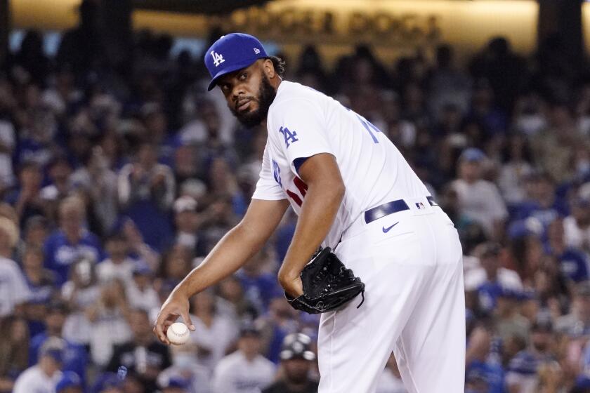 Los Angeles Dodgers relief pitcher Kenley Jansen checks first before pitching during the ninth inning.