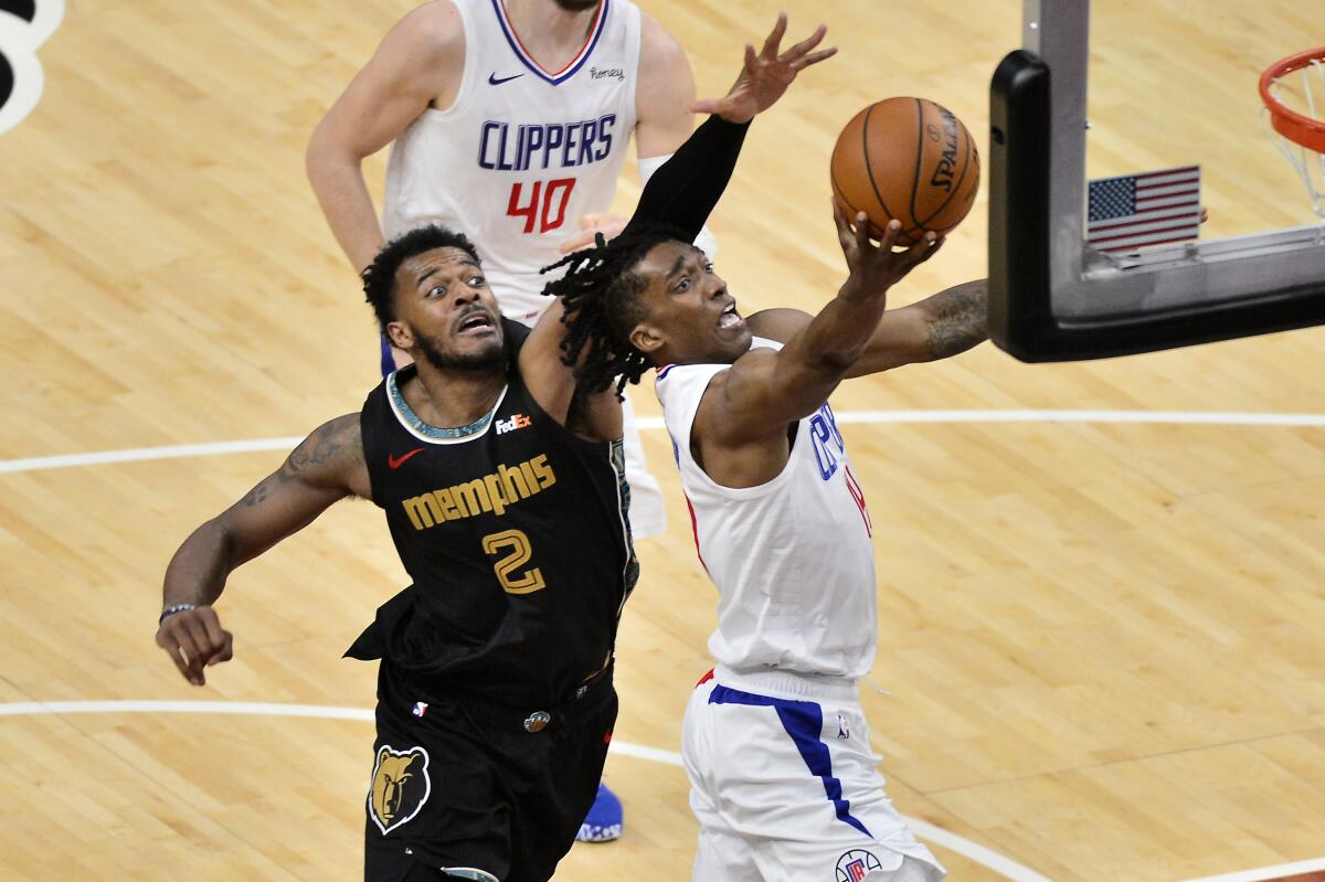 Clippers guard Terance Mann shoots a layup in front of Memphis Grizzlies center Xavier Tillman.