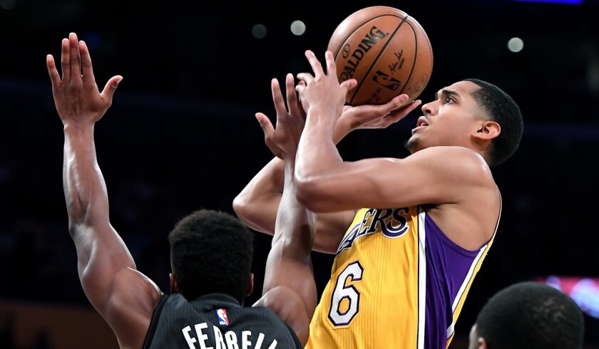 The Lakers' Jordan Clarkson is fouled by the Brooklyn Nets' Yogi Ferrell while making a basket in the third quarter at Staples Center on Nov. 15.