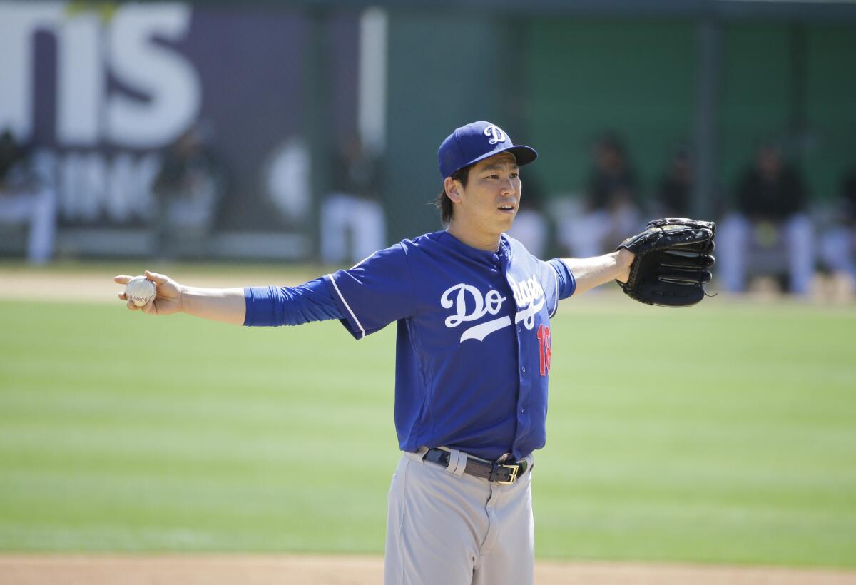 Dodgers right-hander Kenta Maeda stretches during a game against the Chicago White Sox on March 15.