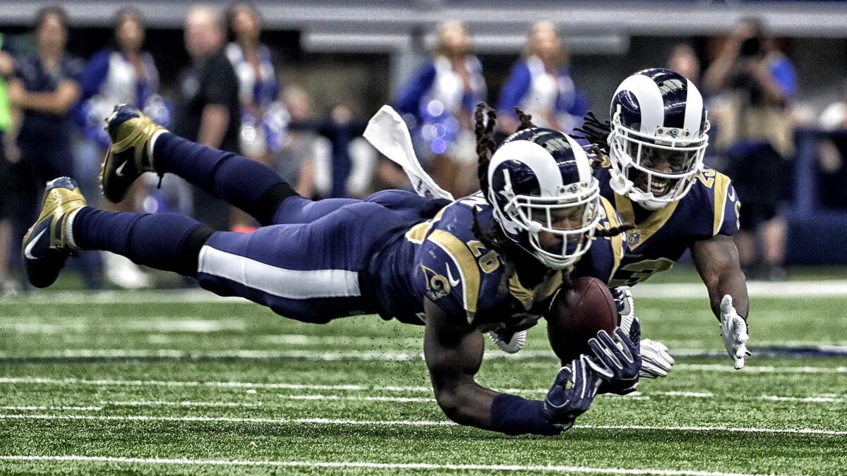Rams linebacker Mark Barron intercepts a pass in front of teammate Nickell Robey-Coleman during a victory over the Cowboys on Oct. 1.