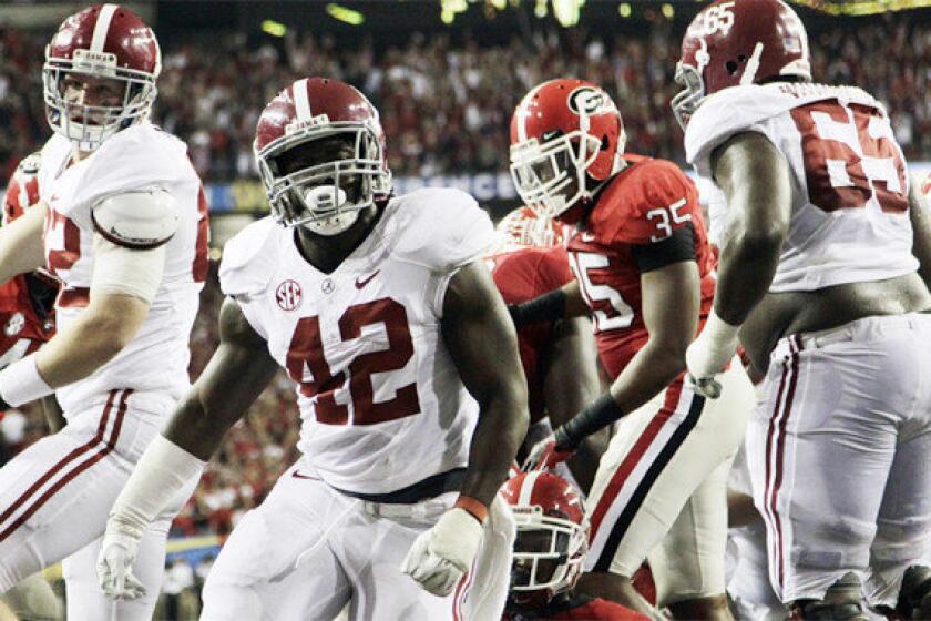 Alabama running back Eddie Lacy (42) reacts after scoring one of his two touchdowns in the Crimson Tide's 32-28 victory over Georgia in the SEC championship game.