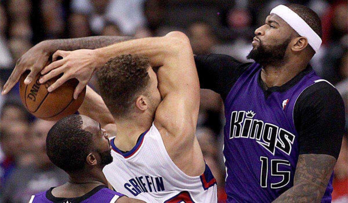 Sacramento's DeMarcus Cousins fouls the Clippers' Blake Griffin on Saturday.