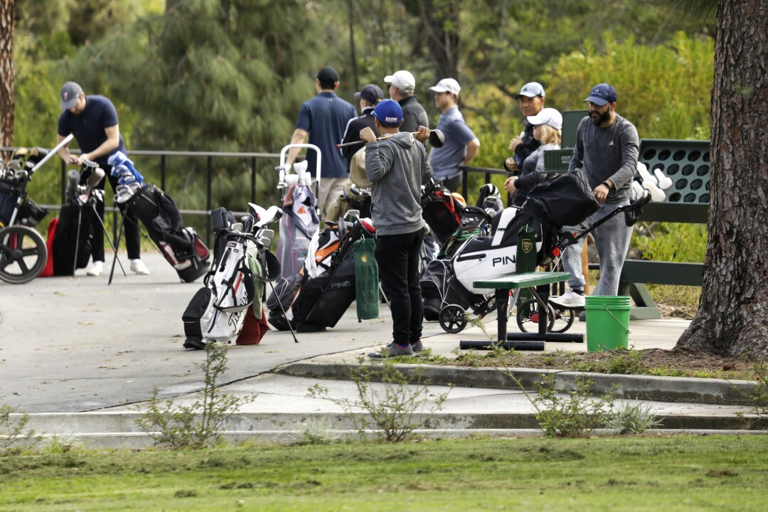 Golfers wait to start at the first hole at Roosevelt Golf Course in Griffith Park.
