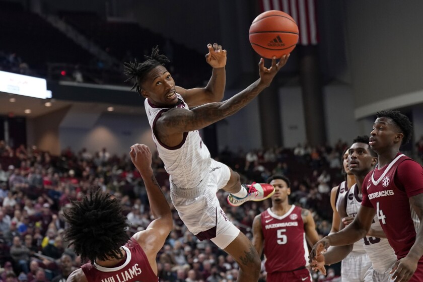 Texas A&M guard Quenton Jackson (3) tries to make a basket after being fouled by Arkansas forward Jaylin Williams (10) during the second half of an NCAA college basketball game Saturday, Jan. 8, 2022, in College Station, Texas. (AP Photo/Sam Craft)