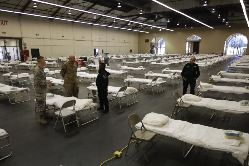 Cots are set up at a possible COVID-19 coronavirus treatment site Wednesday, April 1, 2020, in San Mateo, Calif. The National Guard is currently setting up the federal cache, which includes cots and personal protective equipment needed to establish a federal medical station with capacity up to 250 beds. No patients will be immediately housed in the space but proactively standing it up now allows the County to be ready if and when hospitals need more medical spaces. (AP Photo/Ben Margot, Pool)