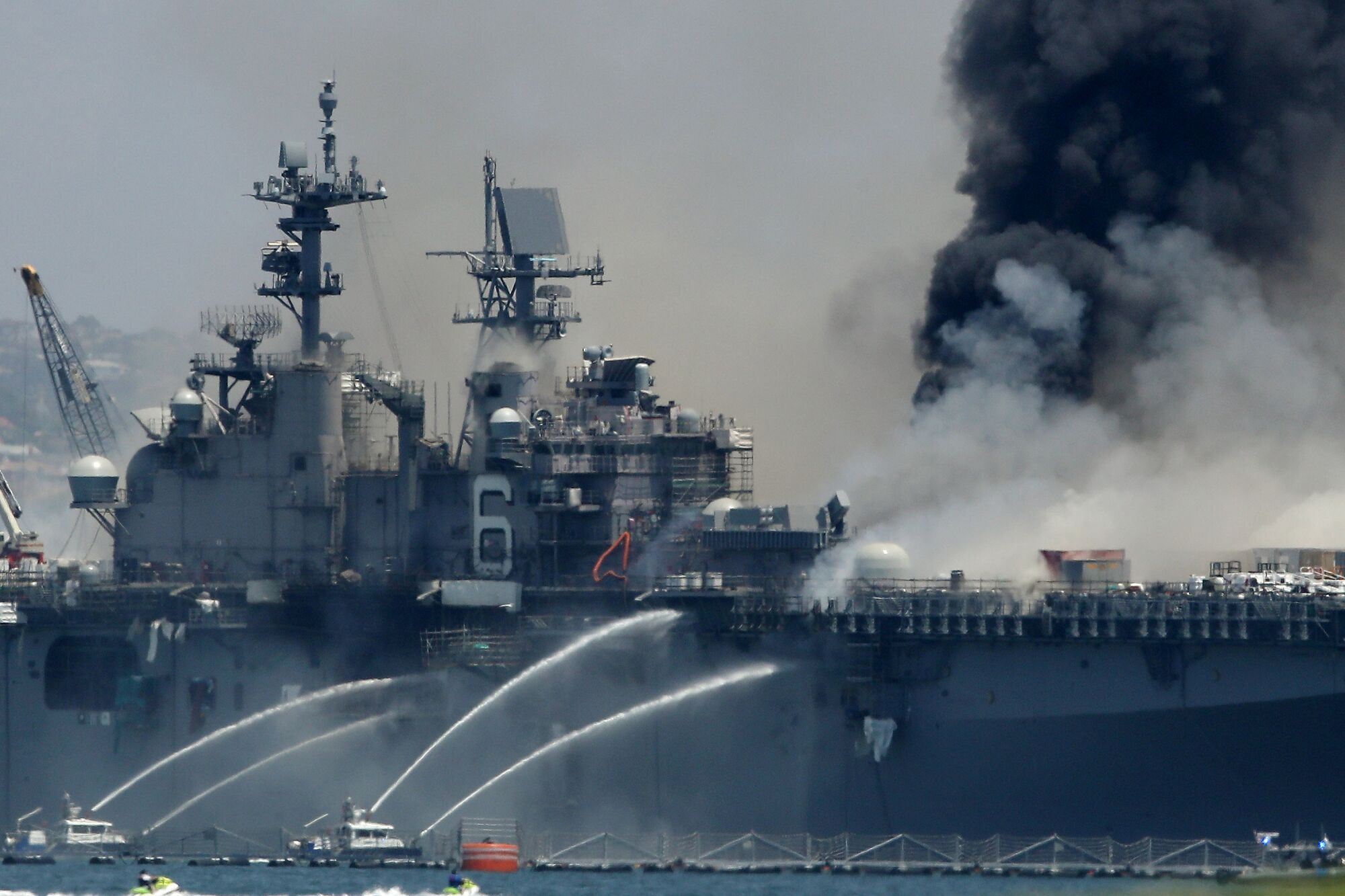 A fire burns on the amphibious assault ship USS Bonhomme Richard at Naval Base San Diego.