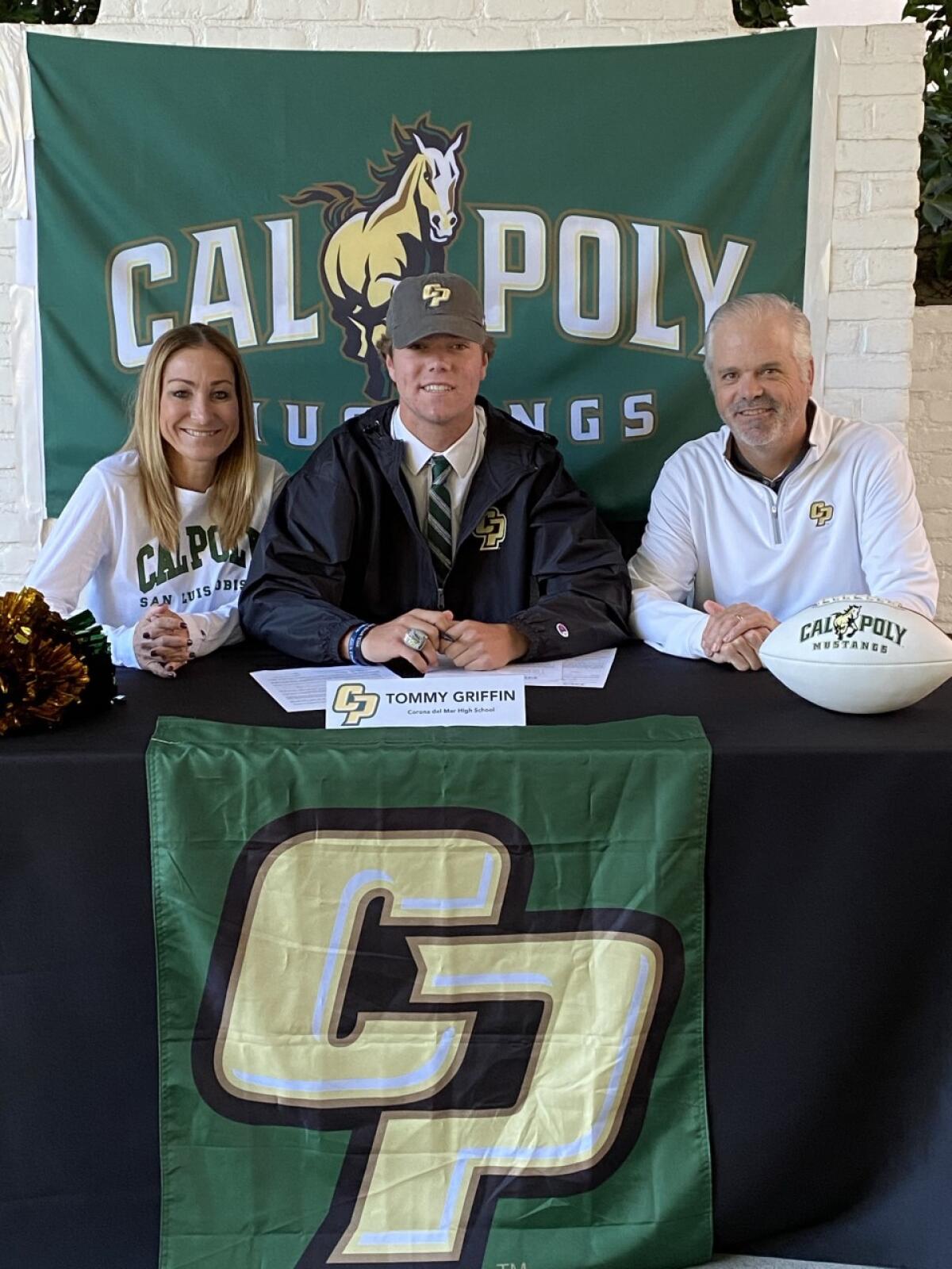 Tommy Griffin, center, signs to play football with Cal Poly San Luis Obispo. His mom, Jill, and dad, John, sit next to him.