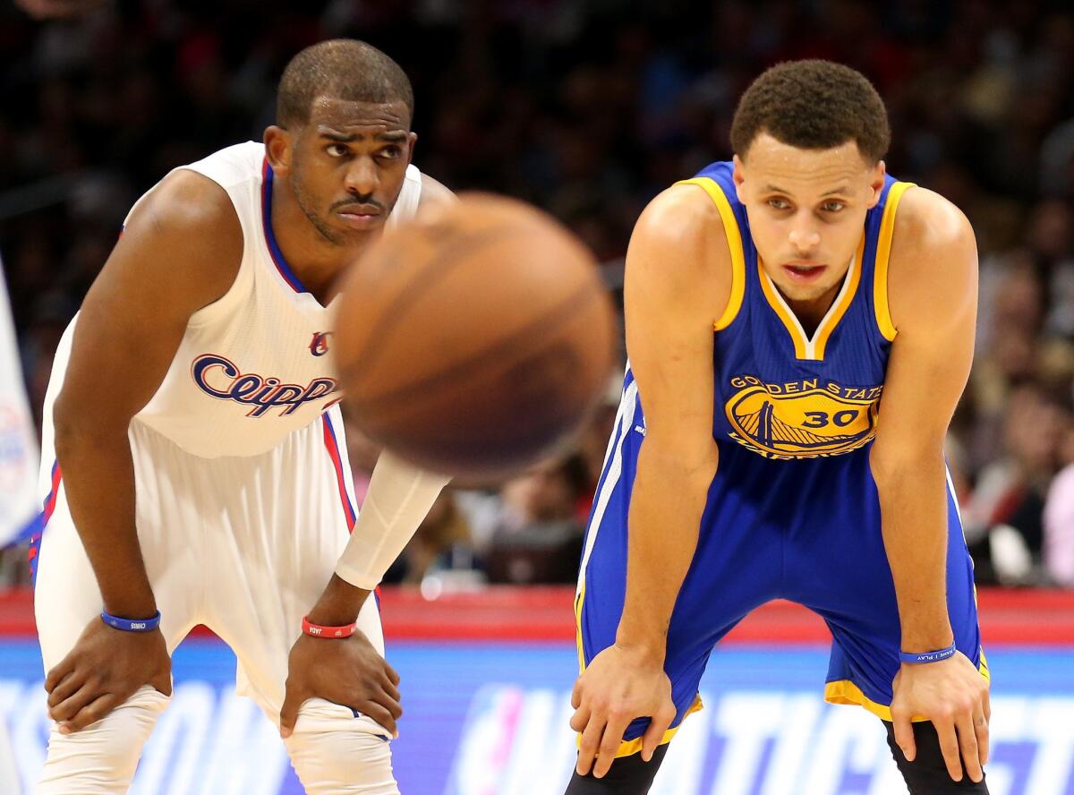 Chris Paul and Golden State guard Stephen Curry wait for a foul shot during the Clippers' 110-106 loss to the Warriors on Tuesday at Staples Center.