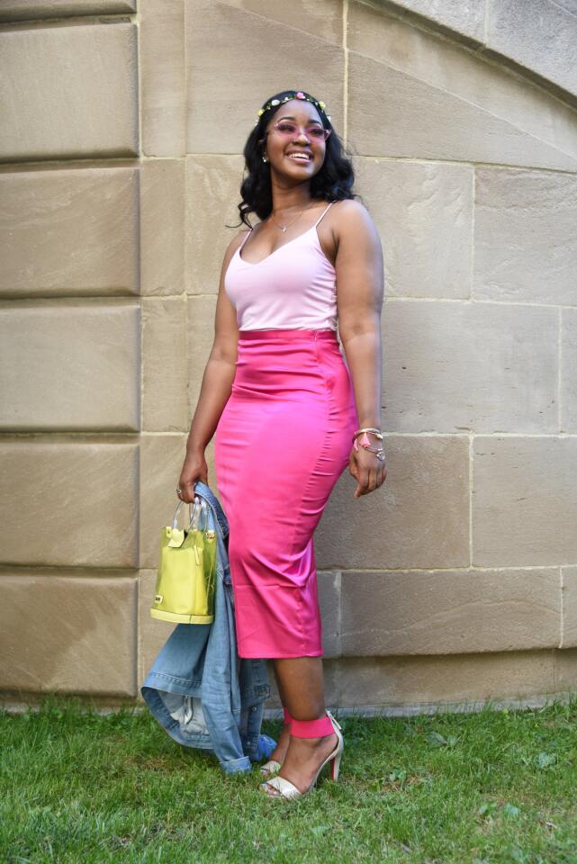 Who: Sydney Young, 22, Woodstock resident, Model Home Interiors interior designer Spotted at: “Rosé in the Garden,” a summer soirée presented by Downtown Partnership of Baltimore at Preston Gardens, downtown Baltimore What she wore: Day & Night baby pink camisole from EDGE; fuchsia stretch satin pencil skirt & denim jacket from Forever 21; taupe & pink ankle strap stilettos, crystal pendant, rose-colored cat-eye glasses and neon yellow bag from Aldo; and collected bangles. When she isn’t wearing black, she goes with monochromatic outfits: “If I wear a color, [the whole outfit] is the same color in different shades. I wear purple a lot that way. It’s my favorite color.”