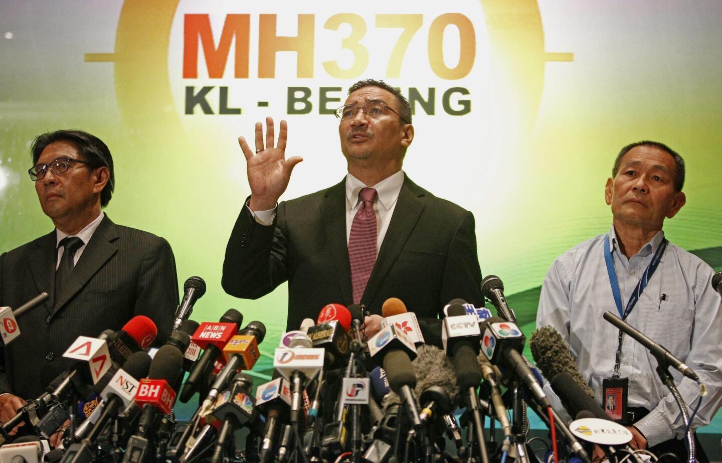 Malaysian Defense Minister and acting Transport Minister Hishammuddin Hussein (C), accompanied by Department Civil Aviation Director General Azharuddin Abdul Rahman (L), and Malaysian Airlines Group CEO Ahmad Jauhari Yahya (R), answers questions during a press conference at the Kuala Lumpur International Airport, in Sepang, outside Kuala Lumpur, Malaysia.