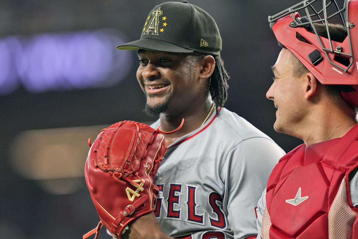 Angels pitcher José Soriano, left, shares a laugh with catcher Matt Thaiss after the last out of the fourth inning Sunday.
