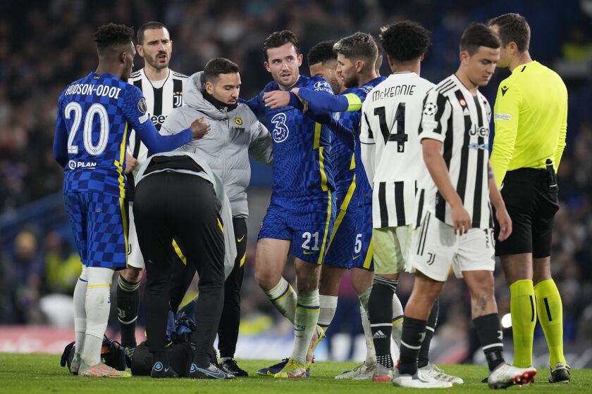 Chelsea's Ben Chilwell, center, receives treatment during the Champions League group H soccer match between Chelsea and Juventus at Stamford Bridge stadium in London, Tuesday, Nov. 23, 2021. (AP Photo/Matt Dunham)