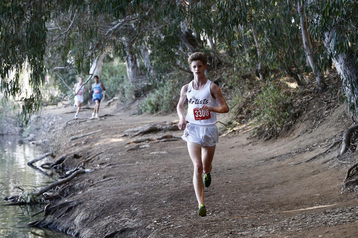 Laguna Beach's Christopher Drews leads the pack against Corona del Mar during a cross-country dual meet at Central Park.