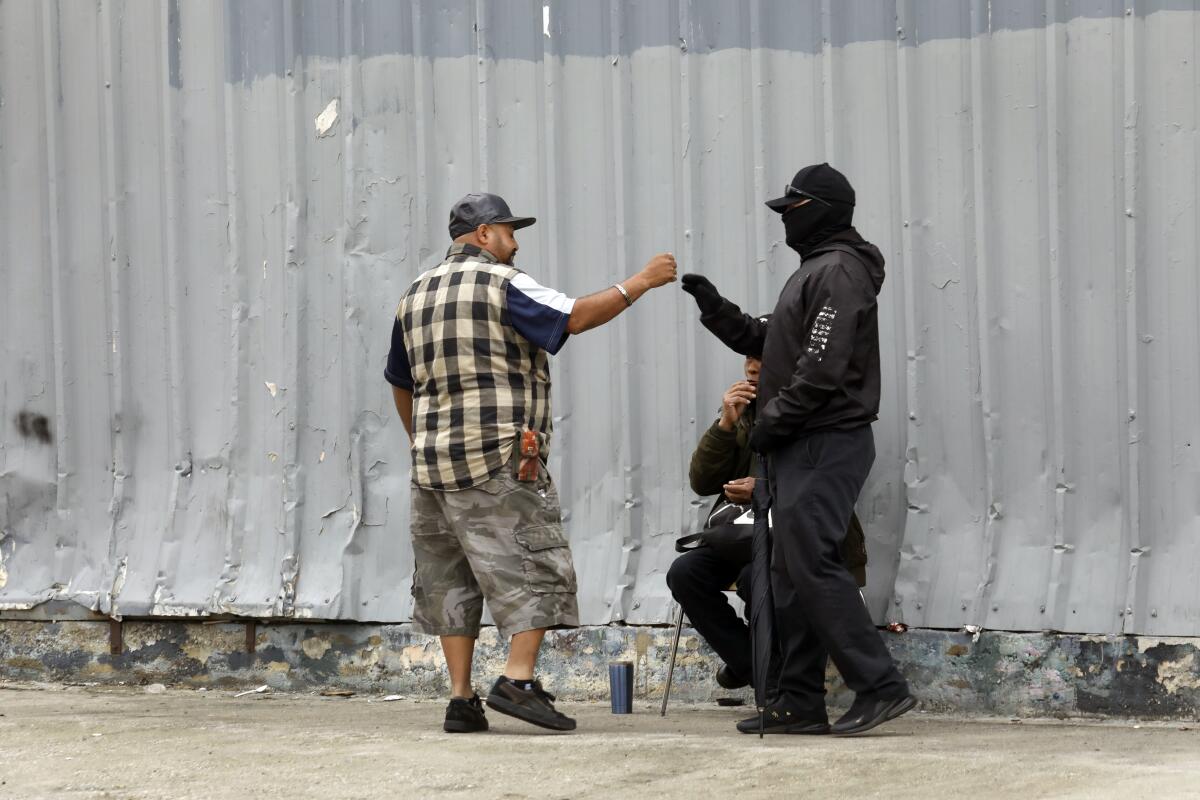 Genaro Guerrera, age 42, left, wait for work outside of U-Haul storage and rental truck in Atwater Village.