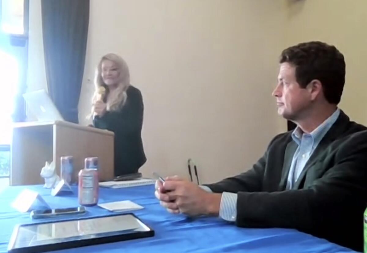 Jerri Hunt addresses the La Jolla Town Council as its new president July 14 as previous president James Rudolph listens.