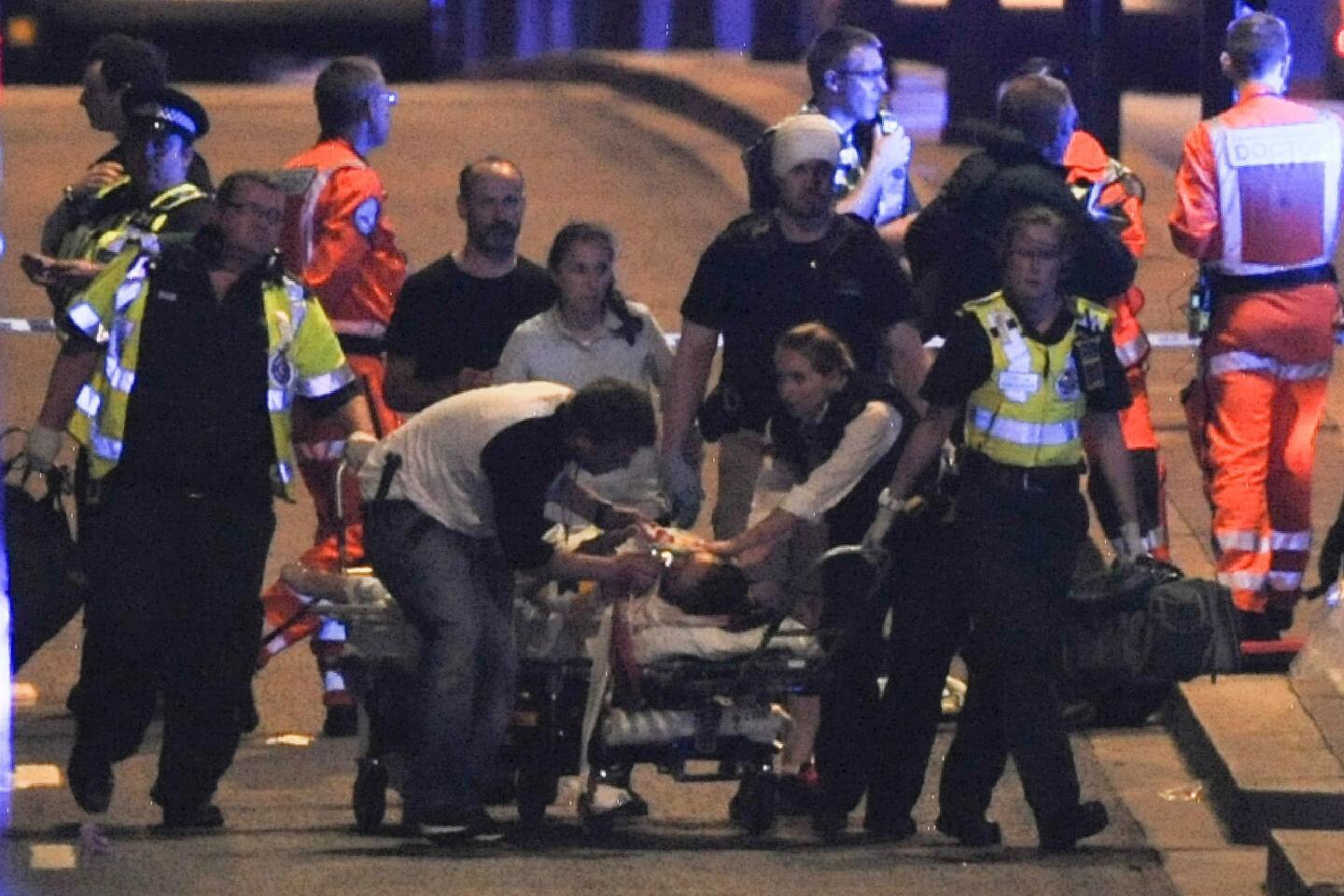Police and emergency crews attend to victims of a terror attack on London Bridge.