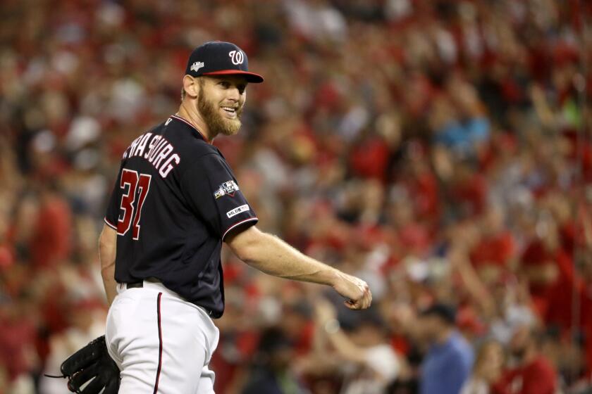 Washington pitcher Stephen Strasburg smiles as he walks back to the dugout during Game 3 of the National League Championship Series against the St. Louis Cardinals on Oct. 14 at Nationals Park.