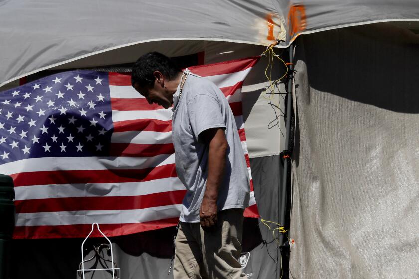 LOS ANGELES, CALIF. - JULY 4, 2020. American flags decorate tents at an encampment of homeless veterans along San Vicente Boulevard in Brentwood on Saturday, July 4, 2020. (Luis Sinco/Los Angeles Times)
