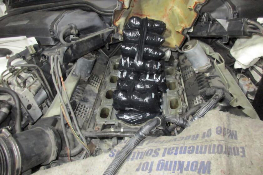 This Sept. 12, 2021 photo provided by the U.S. Customs and Border Protection shows drugs concealed inside the engine of a car. A former Marine who for years helped smuggle drugs from Mexico into the United States has been sentenced to 12 years in federal prison. Twenty-six-year-old Roberto Salazar II of San Diego was sentenced Friday, April 21, 2023, for importing fentanyl and for conspiracy to distribute heroin, methamphetamine, cocaine and fentanyl. (U.S. Customs and Border Protection via AP)