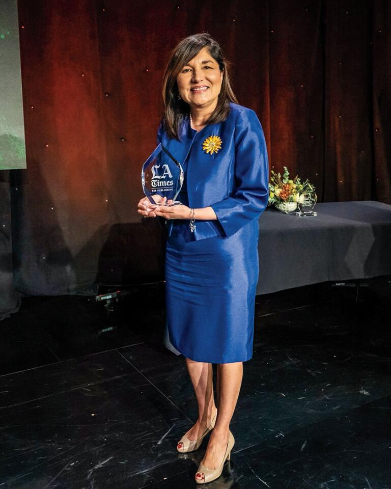 Maria Salinas (Los Angeles Area Chamber of Commerce) proudly displays her award.