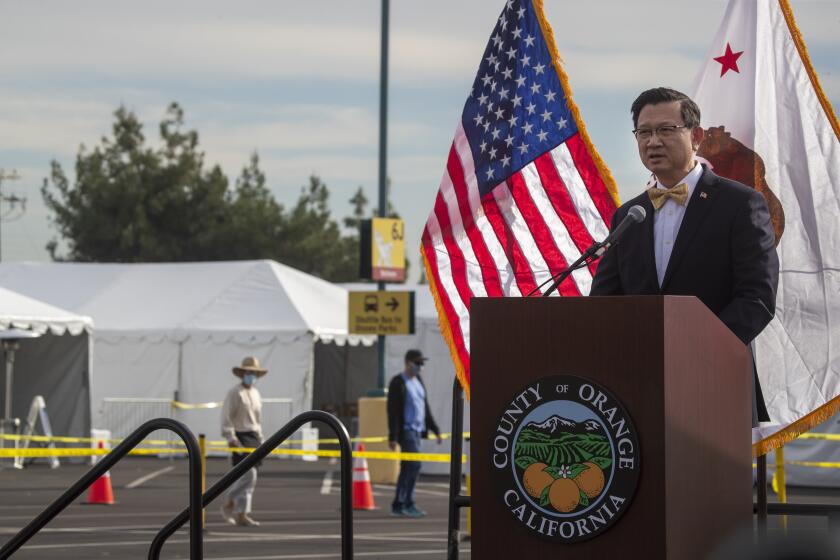 Anaheim, CA - January 13: Orange County First District supervisor Andrew Do. speaks at a news conference as Orange County active Phase 1A (critical and healthcare workers) residents exit large tents at Orange County's first large-scale vaccination site after receiving the Moderna COVID-19 vaccine in the Toy Story parking lot at the Disneyland Resort in Anaheim Wednesday, Jan. 13, 2021. Orange County supervisors and Orange County Health Care Agency Director Dr. Clayton Chau held a news conference discussing the county's first Super POD (point-of-dispensing) site for COVID-19 vaccine distribution. The vaccinations are at Tier 1A for people who have reservations on a website. The site is able to handle 7,000 immunizations per day. Their goal is to immunize everyone in Orange County who chooses to do so by July 4th. (Allen J. Schaben / Los Angeles Times)