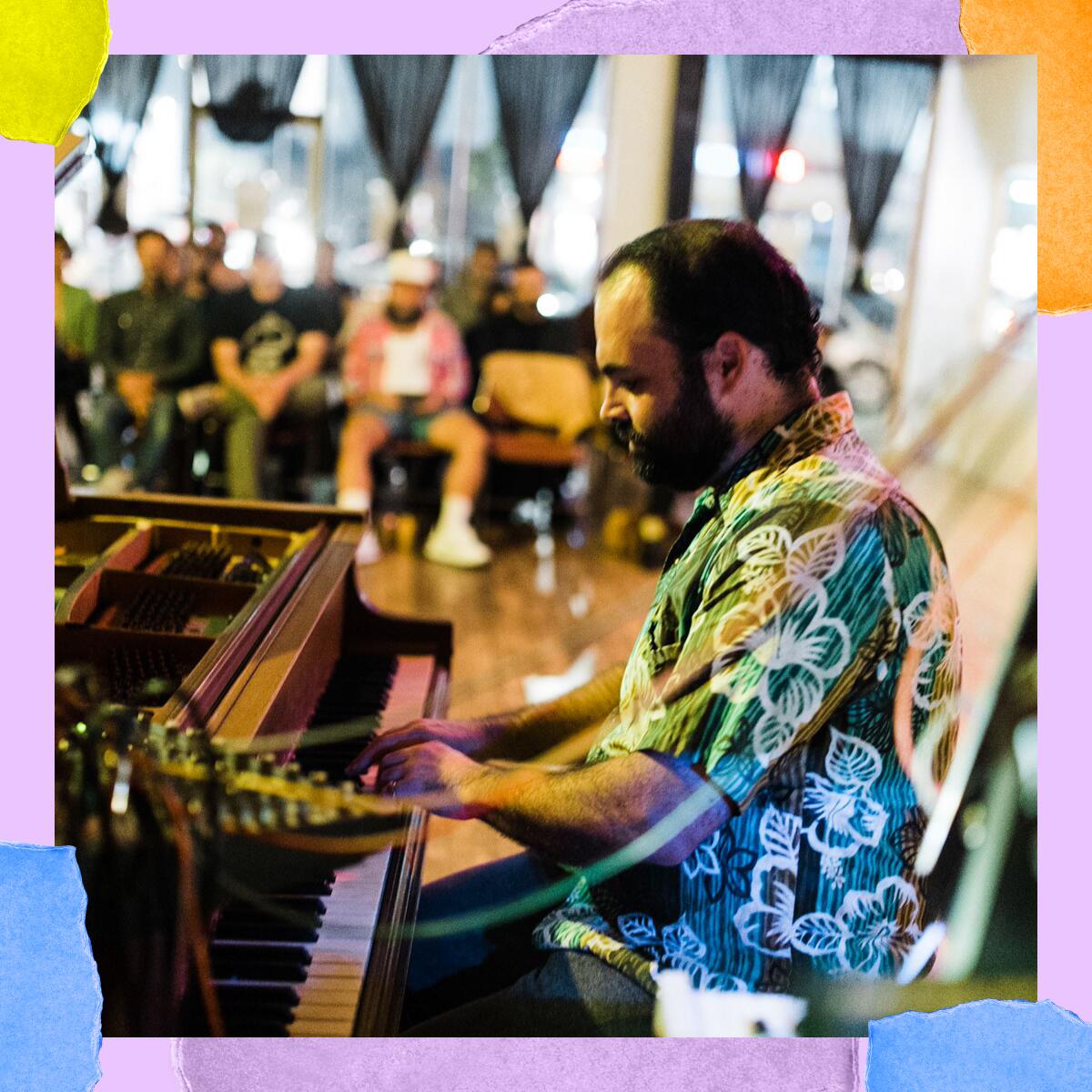 Close-up of a man in a Hawaiian shirt playing a grand piano. In the background, casually dressed people sit in chairs.