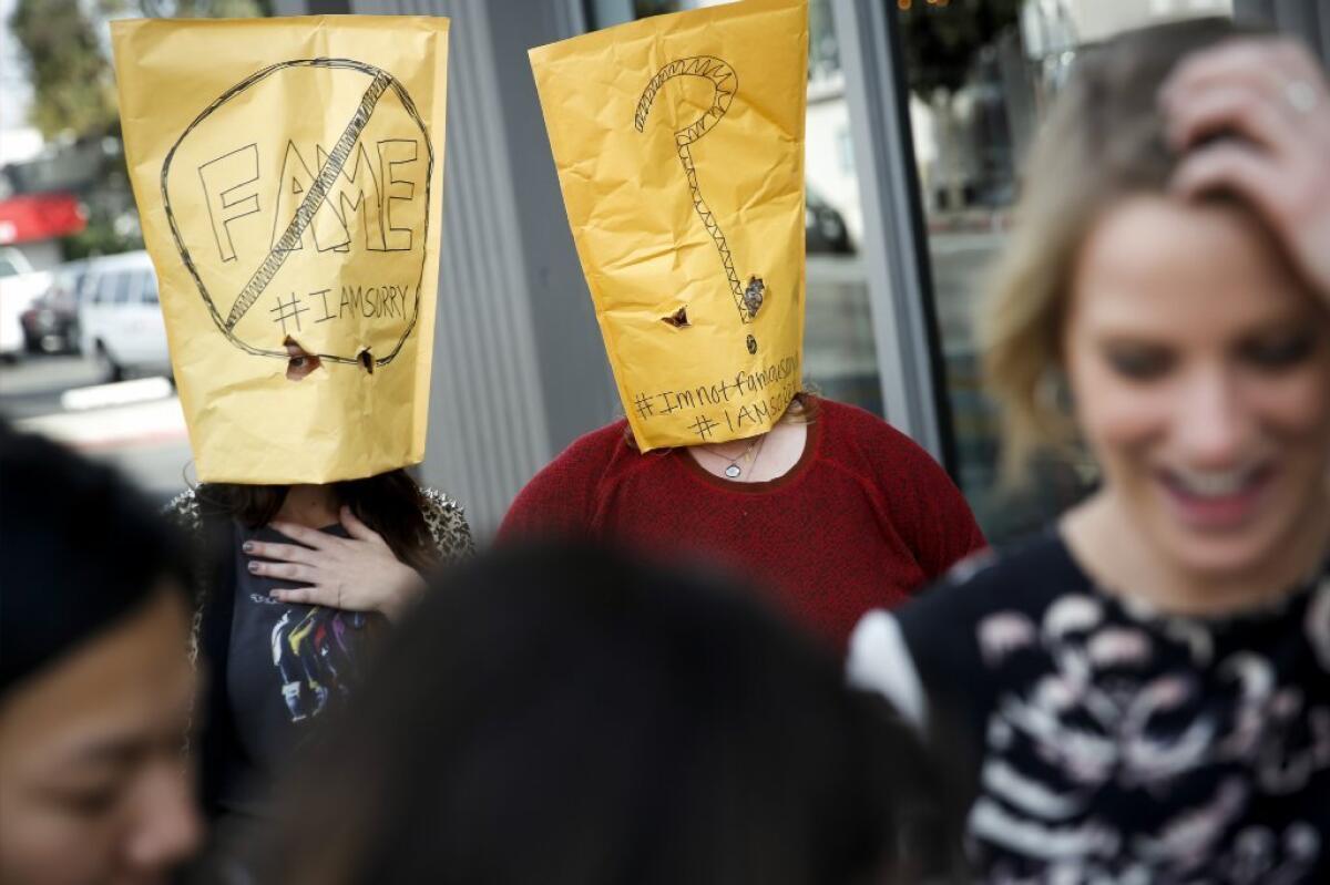 Two women wearing envelopes over their heads with #IAMSORRY written on them, among other things, waited in line for their opportunity to enter Shia LeBeouf's "#IAMSORRY" installation/performance/apology at the Cohen Gallery.