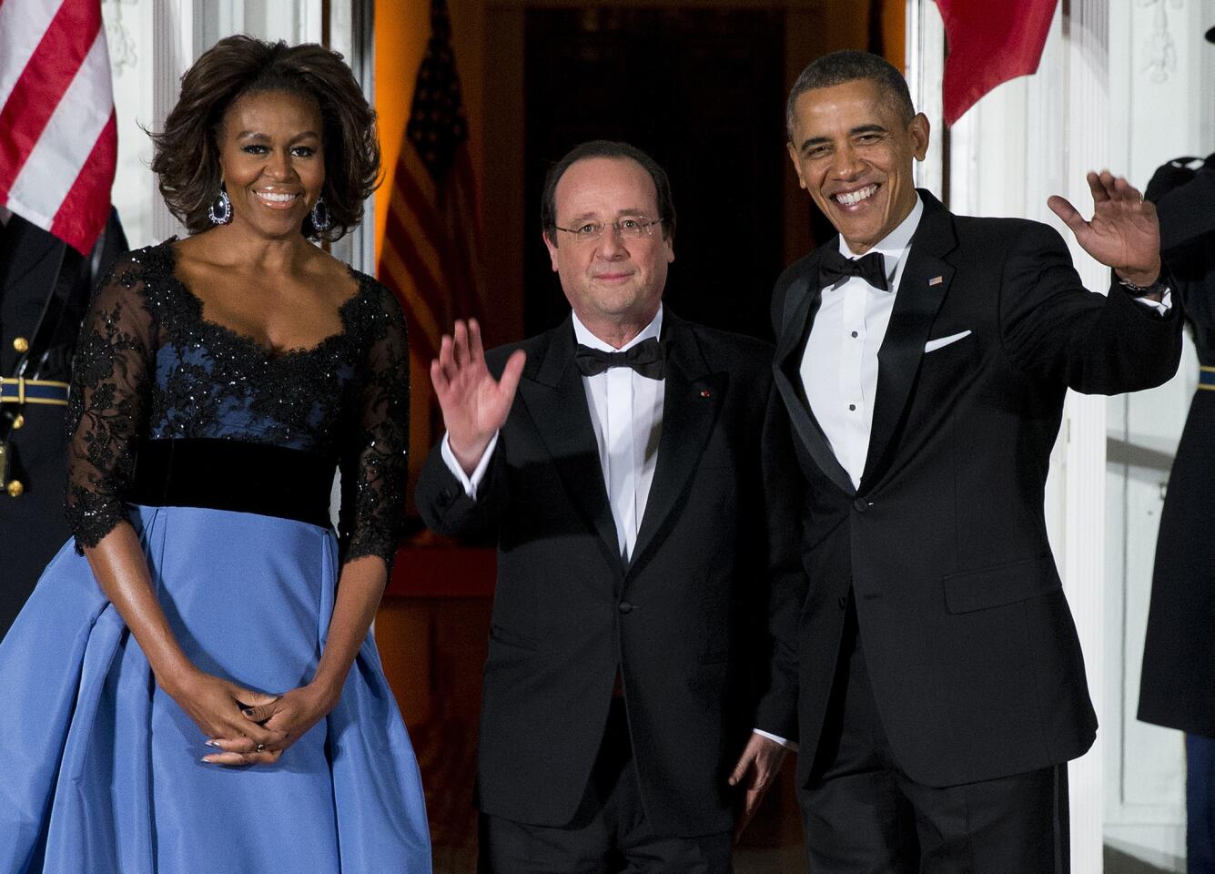 First lady Michelle Obama, left, and President Barack Obama welcome French President Francois Hollande for a State Dinner at the North Portico of the White House. The trip is taking place amid speculation about problems in Hollande's personal life.