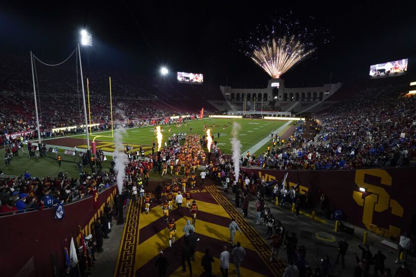 Southern California football players enter the field before an NCAA college football game against BYU in Los Angeles, Saturday, Nov. 27, 2021. (AP Photo/Ashley Landis)