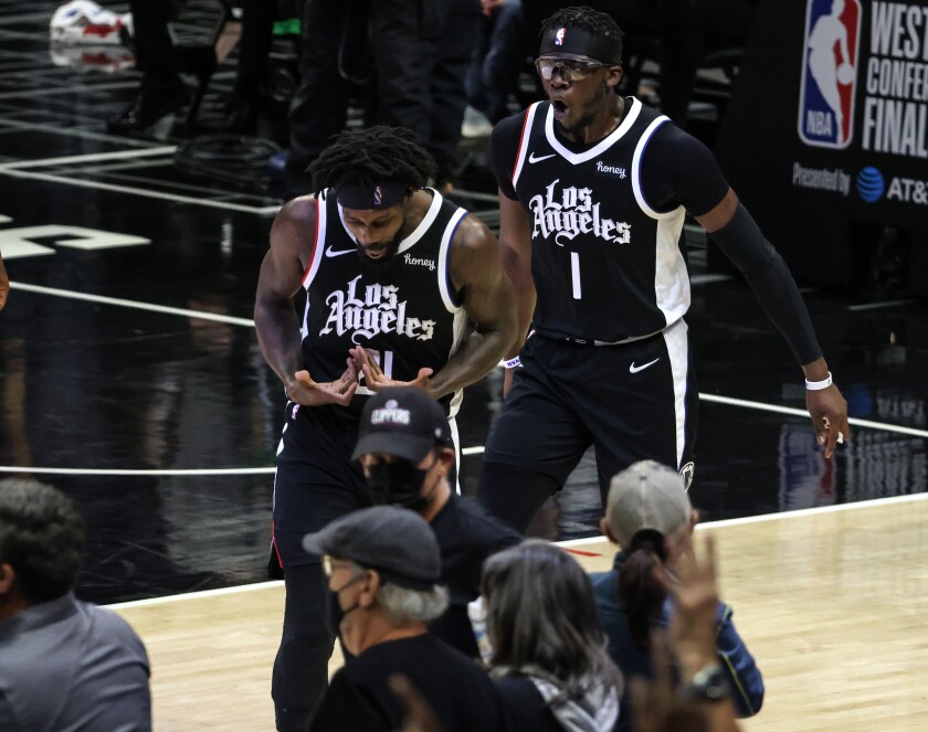 Reggie Jackson (1) and Patrick Beverley celebrate as the Clippers ice a victory over the Phoenix Suns.