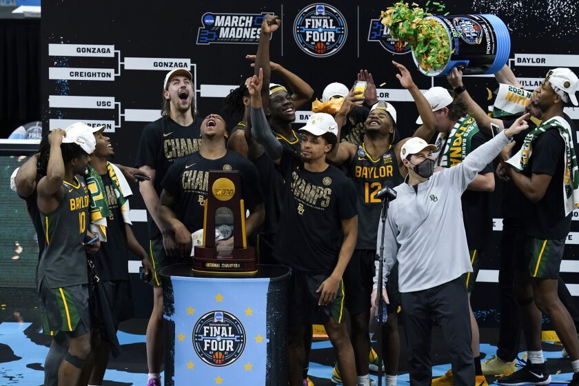 Baylor players and coaches celebrate after the championship game against Gonzaga in the men's Final Four NCAA college basketball tournament, Monday, April 5, 2021, at Lucas Oil Stadium in Indianapolis. Baylor won 86-70. (AP Photo/Darron Cummings)