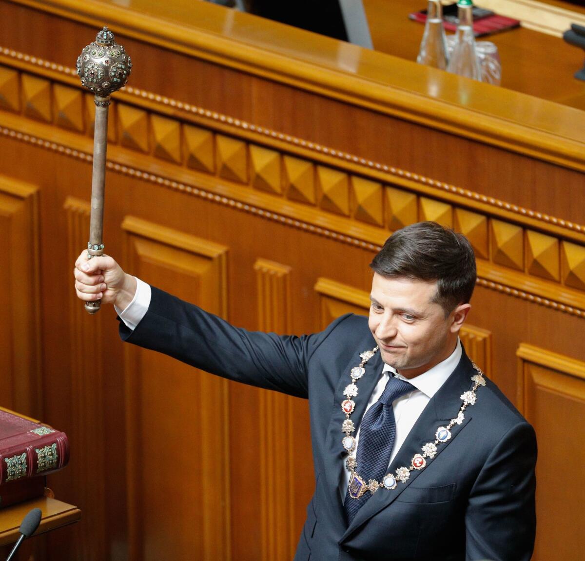 Volodymyr Zelensky holds an ancient Bulava, a symbol of state power, during his inauguration in parliament in Kiev, Ukraine, on May 20.