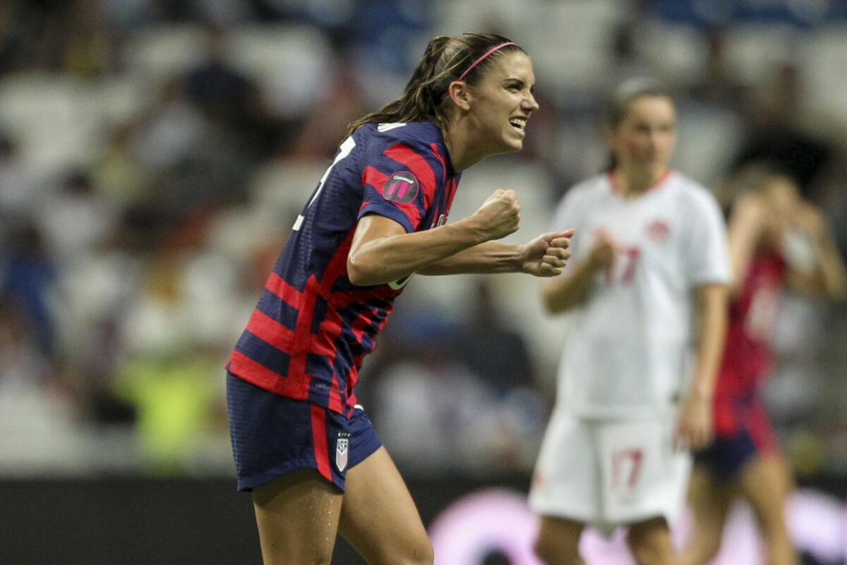 United States' Alex Morgan celebrates scoring her side's opening goal from the penalty spot against Canada.