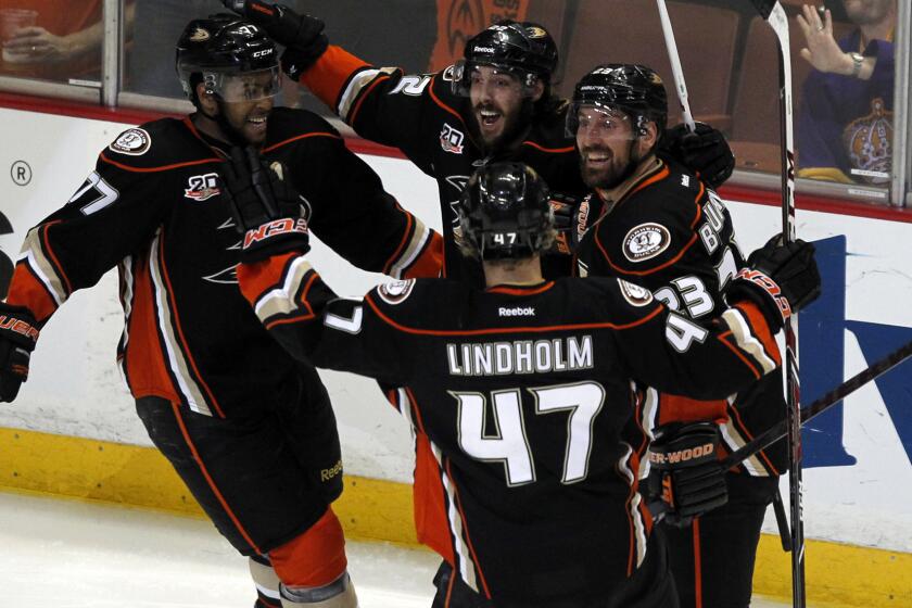 Ducks teammates celebrate a goal by Devante Smith-Pelly, far left, during the second period of the team's 4-3 win over the Kings in Game 5 of the Western Conference semifinals at Honda Center on Monday.