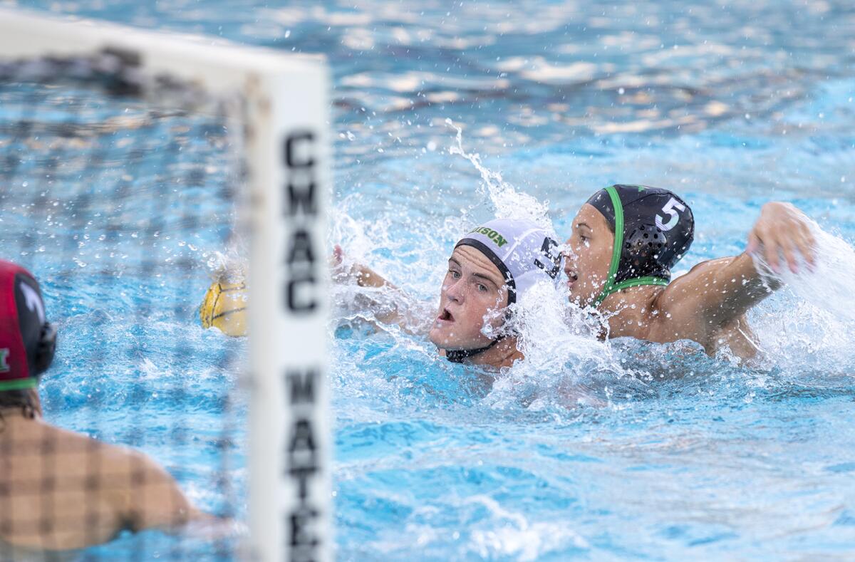 Edison's Everett Rowden battles with Costa Mesa's Wyatt Juelfs during a CIF Division 2 boys' water polo playoff game.